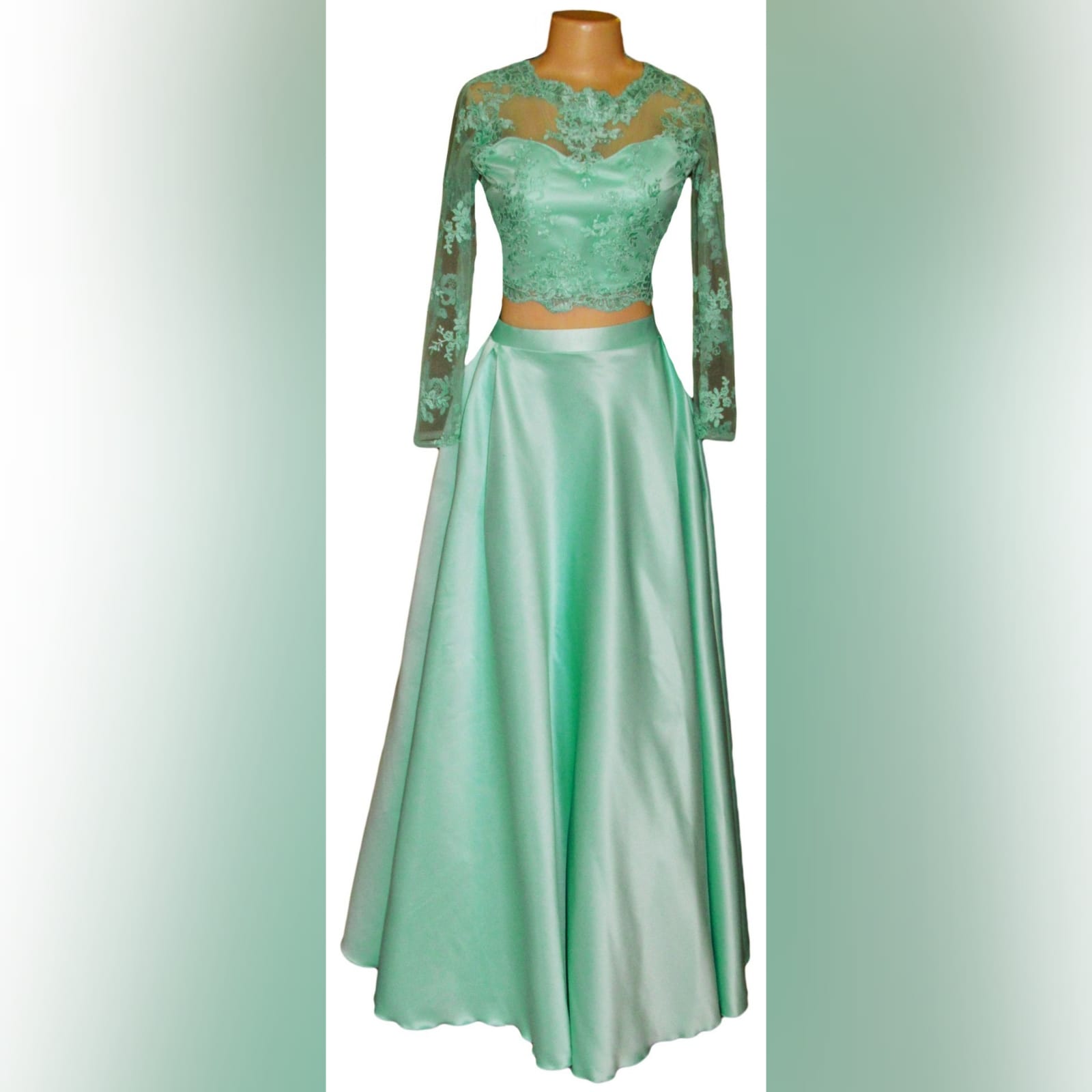 2 piece baby green prom dance dress lace crop top 3 2 piece baby green prom dress lace crop top with a diamond open back and long sleeves. With a long skirt.