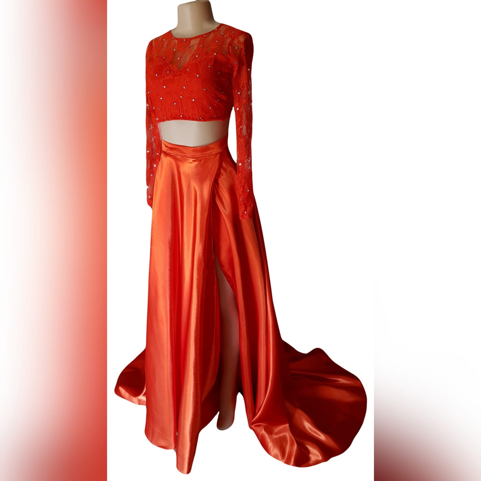2 piece orange prom dress with a lace crop top 11 2 piece orange prom dress with a lace crop top detailed with silver beads. Flowy, shiny skirt with crossed slit and long train.