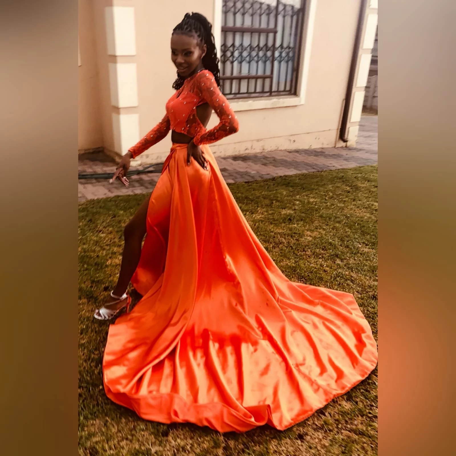 2 piece orange prom dress with a lace crop top 10 2 piece orange prom dress with a lace crop top detailed with silver beads. Flowy, shiny skirt with crossed slit and long train.