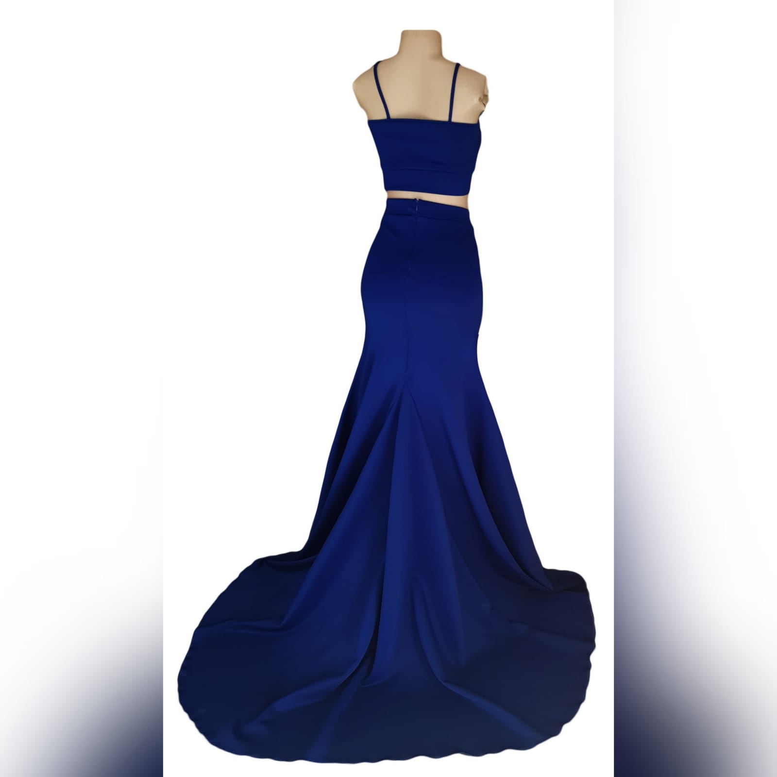 2 piece royal blue prom dress 3 2 piece royal blue prom dress. Crop top with cleavage opening. Fitted skirt with a slit and a train.