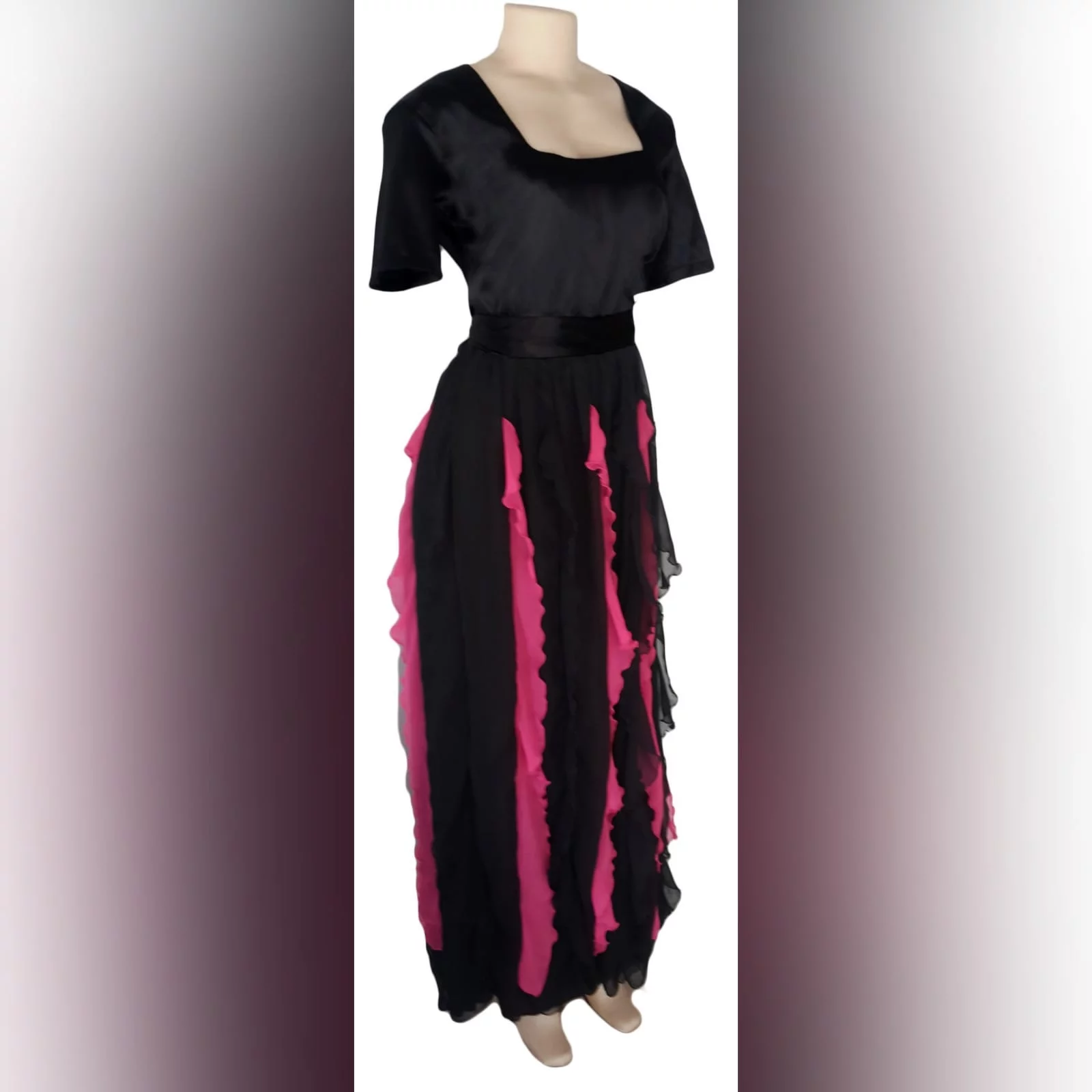 Black and pink evening dress 1 black & pink evening dress with square neckline short sleeves & vertical pink and black frills