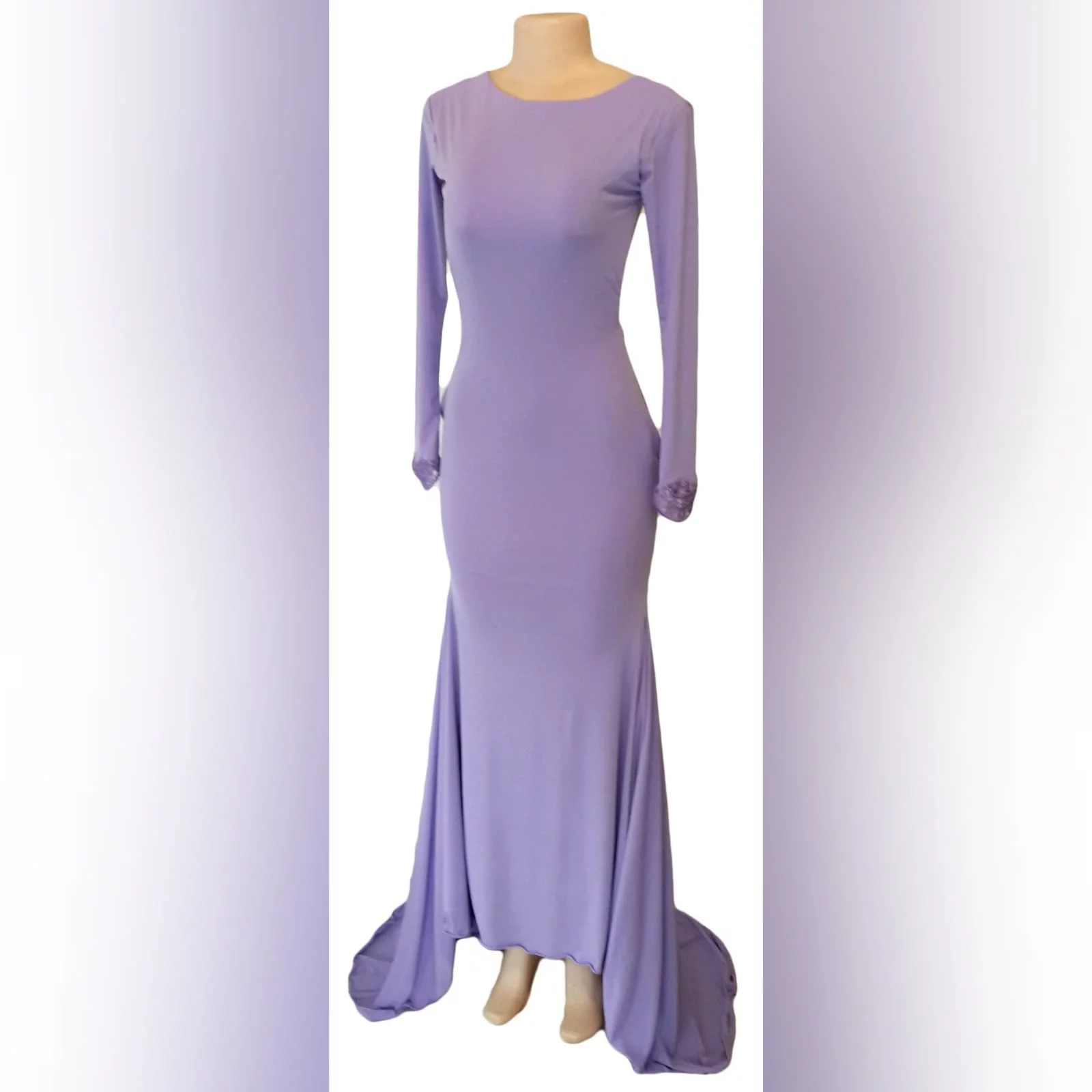 Body fitting lilac soft mermaid matric farewell dress and a jewel neckline 4 body fitting lilac soft memaid matric farewell dress and a jewel neckline. Low open square back. With a train and long sleeves. Sleeves finished with lace.