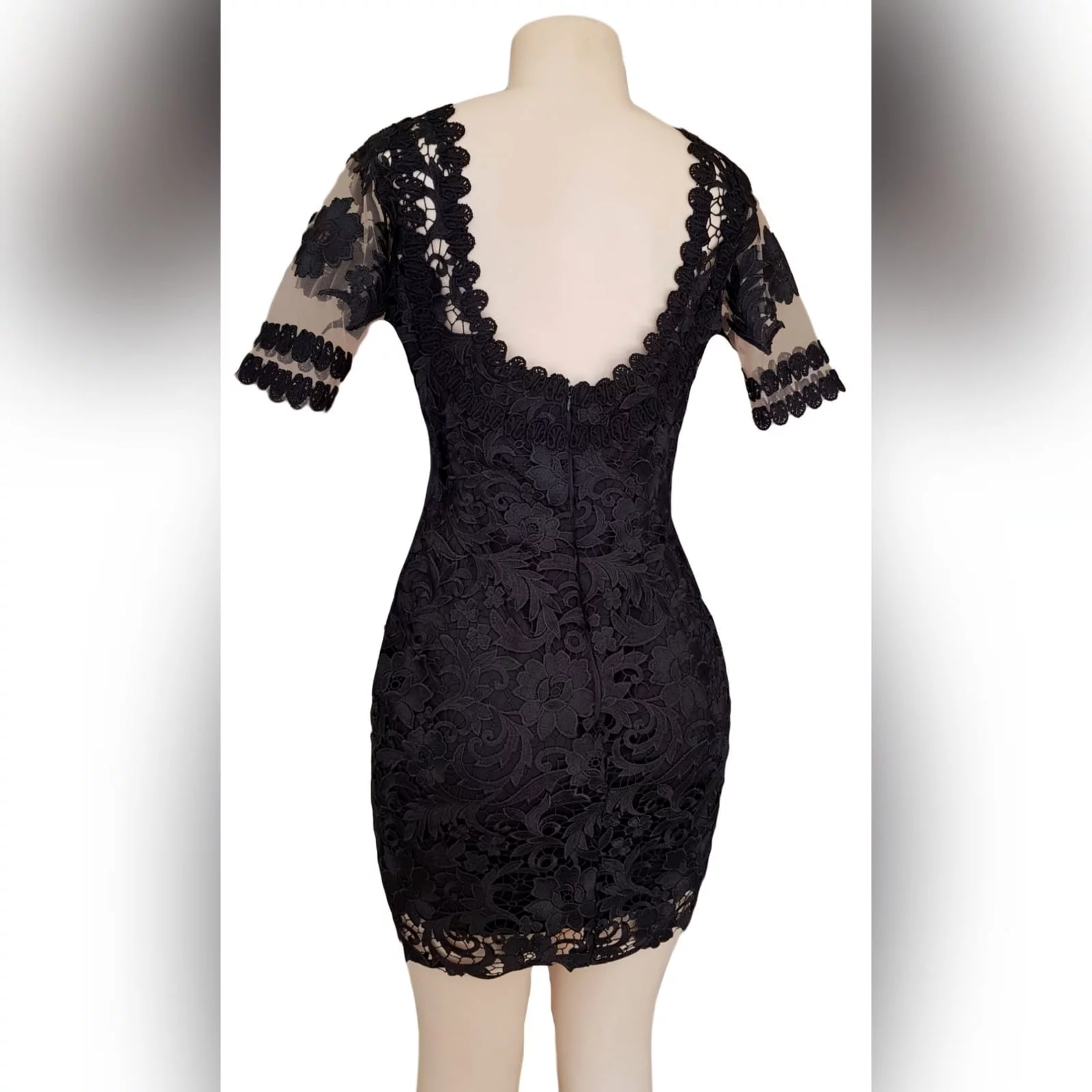 Black short guipure lace evening dress 2 black short guipure lace evening dress with a rounded front and back neckline. With sheers short sleeves detailed with lace.