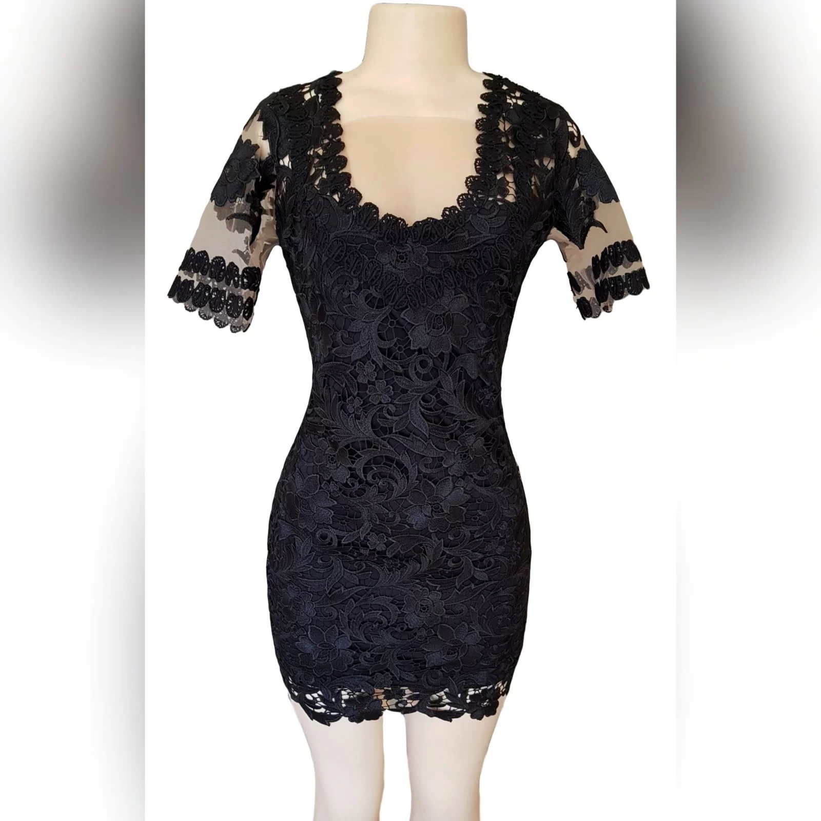 Black short guipure lace evening dress 1 black short guipure lace evening dress with a rounded front and back neckline. With sheers short sleeves detailed with lace.