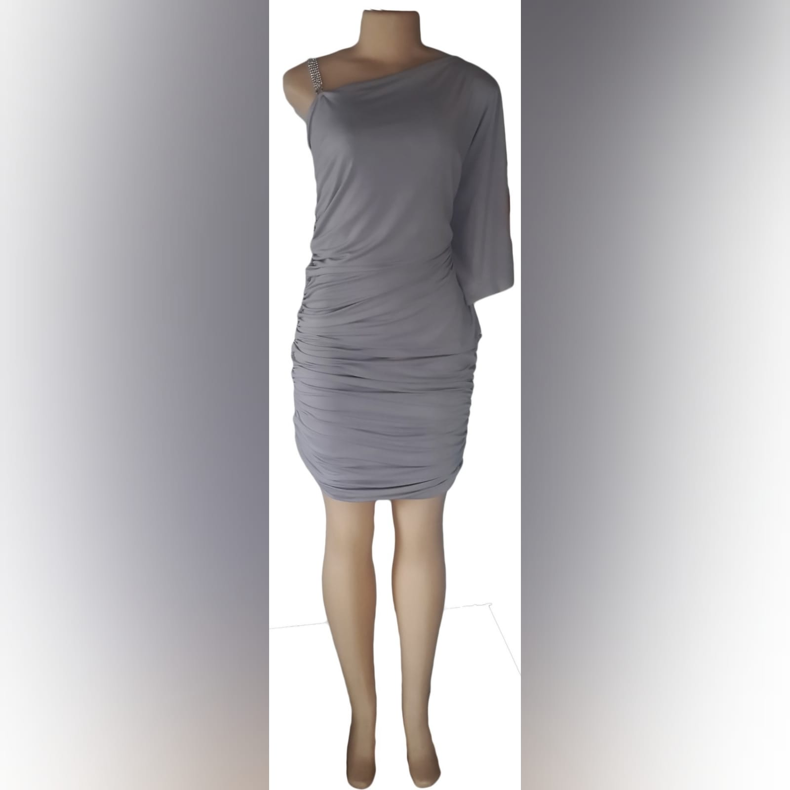 Light grey ruched knee length smart casual dress 1 light grey ruched knee length smart casual dress with one wide sleeve, an angular neckline and a removable diamante shoulder strap.