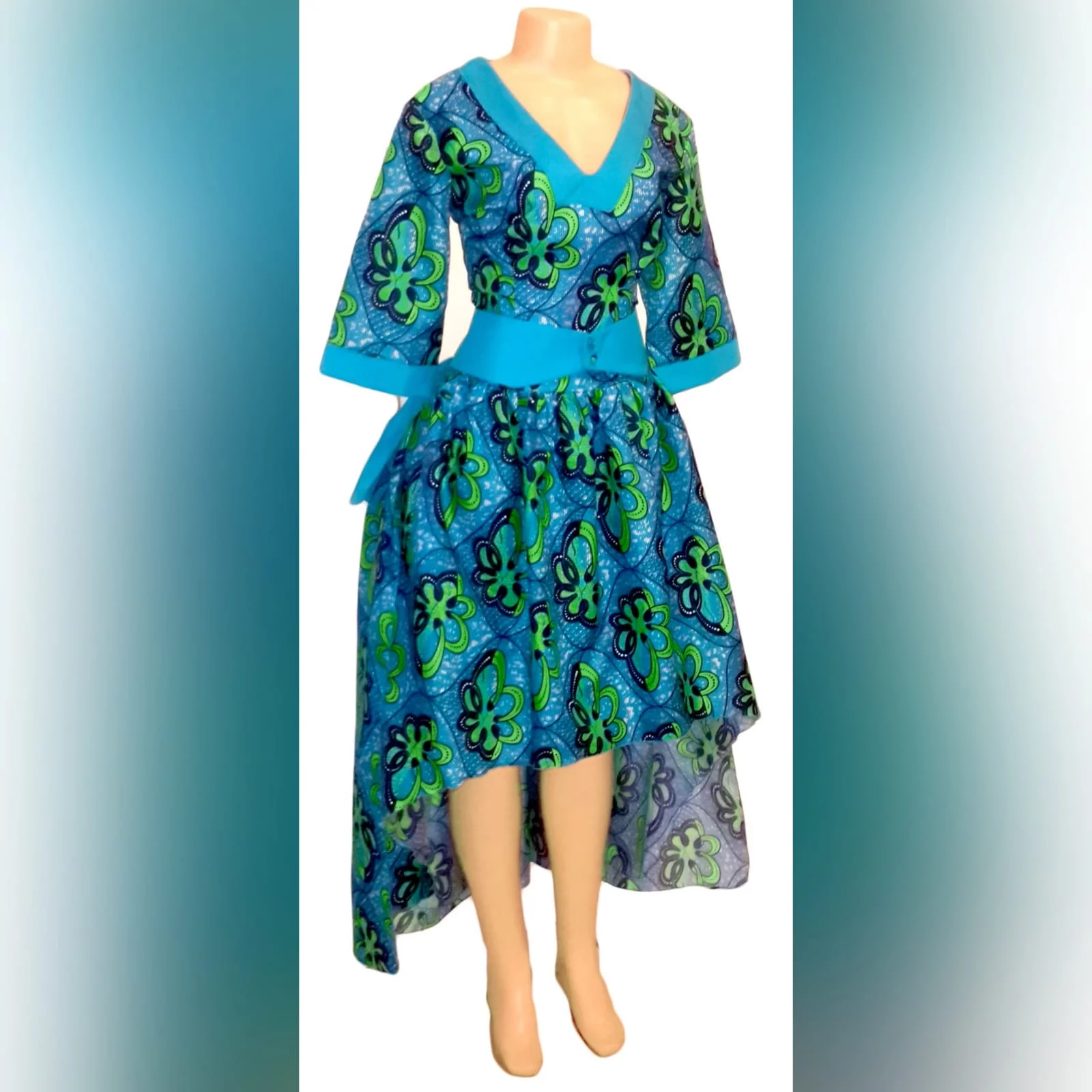 Modern traditional green and blue high low dress 5 modern traditional green and blue hi lo dress with a v neckline, 3/4 sleeves and a back peplum with a waistbelt. Matching doek.