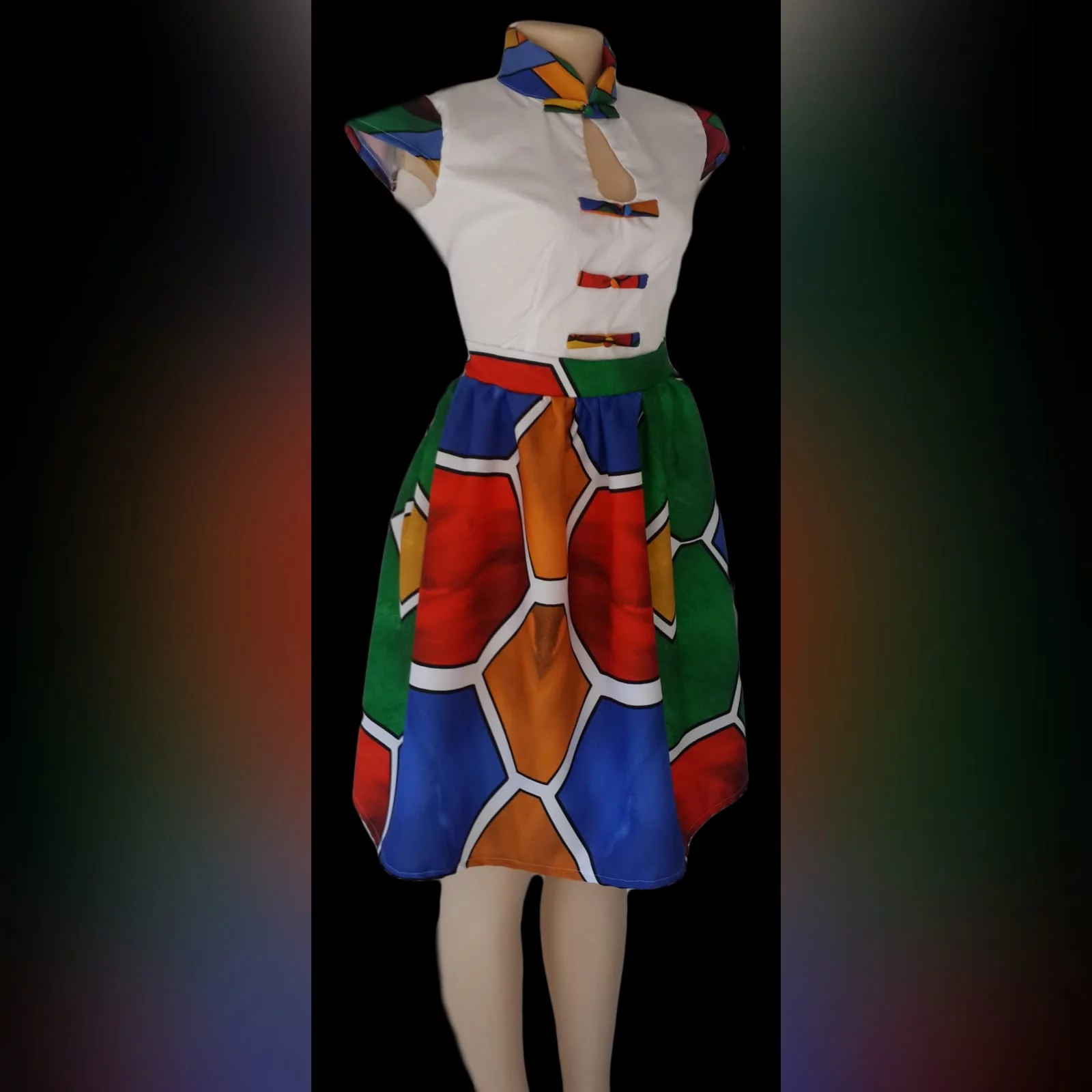 Vestido curto de tecido africano ndebele 1 vestido tradicional ndebele, corpete branco, colarinho chinês, mangas e detalhe de botões na impressão ndebele. Parte inferior do vestido em impressão ndebele completa.