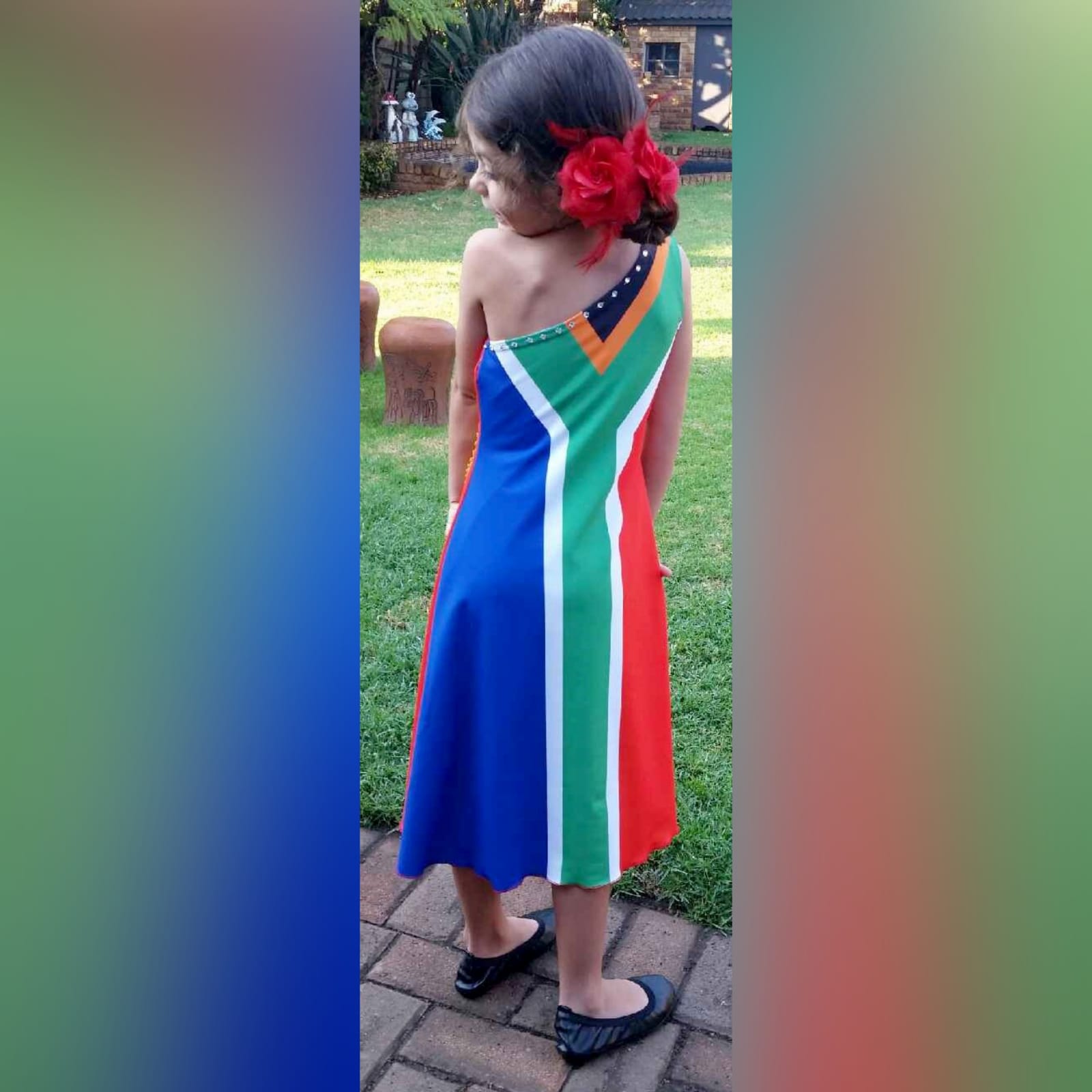 Portuguese flag and south african flag dress 2 single shoulder dress with the portuguese flag in the front and the south african flag at the back. Bead detailing on the front and the back. Worn for heritage day. She won a prize for best dressed.