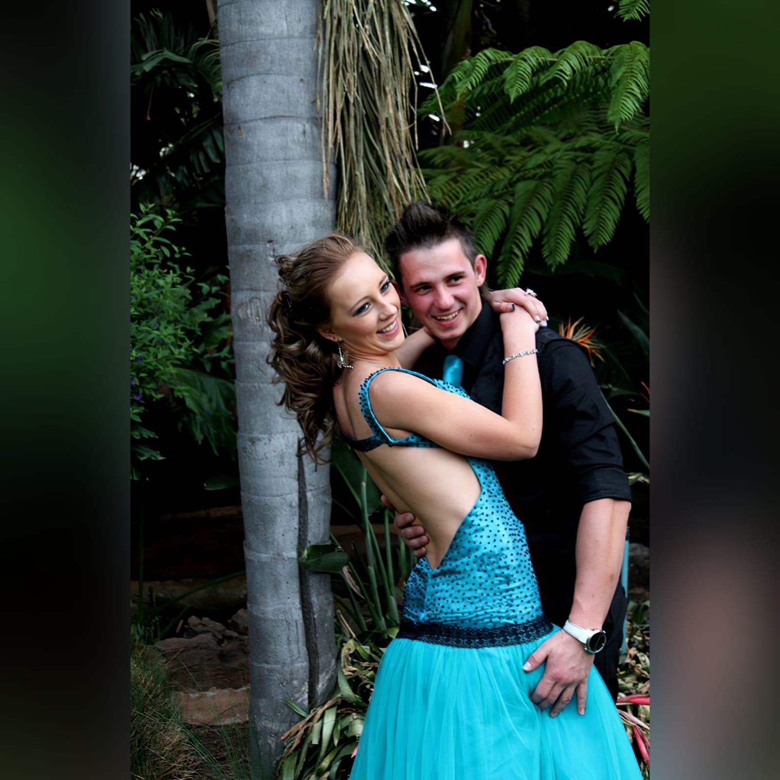Turquoise blue and black prom dress 4 turquoise blue and black prom dress with a scattered beaded bodice with a low open back and a tulle bottom.