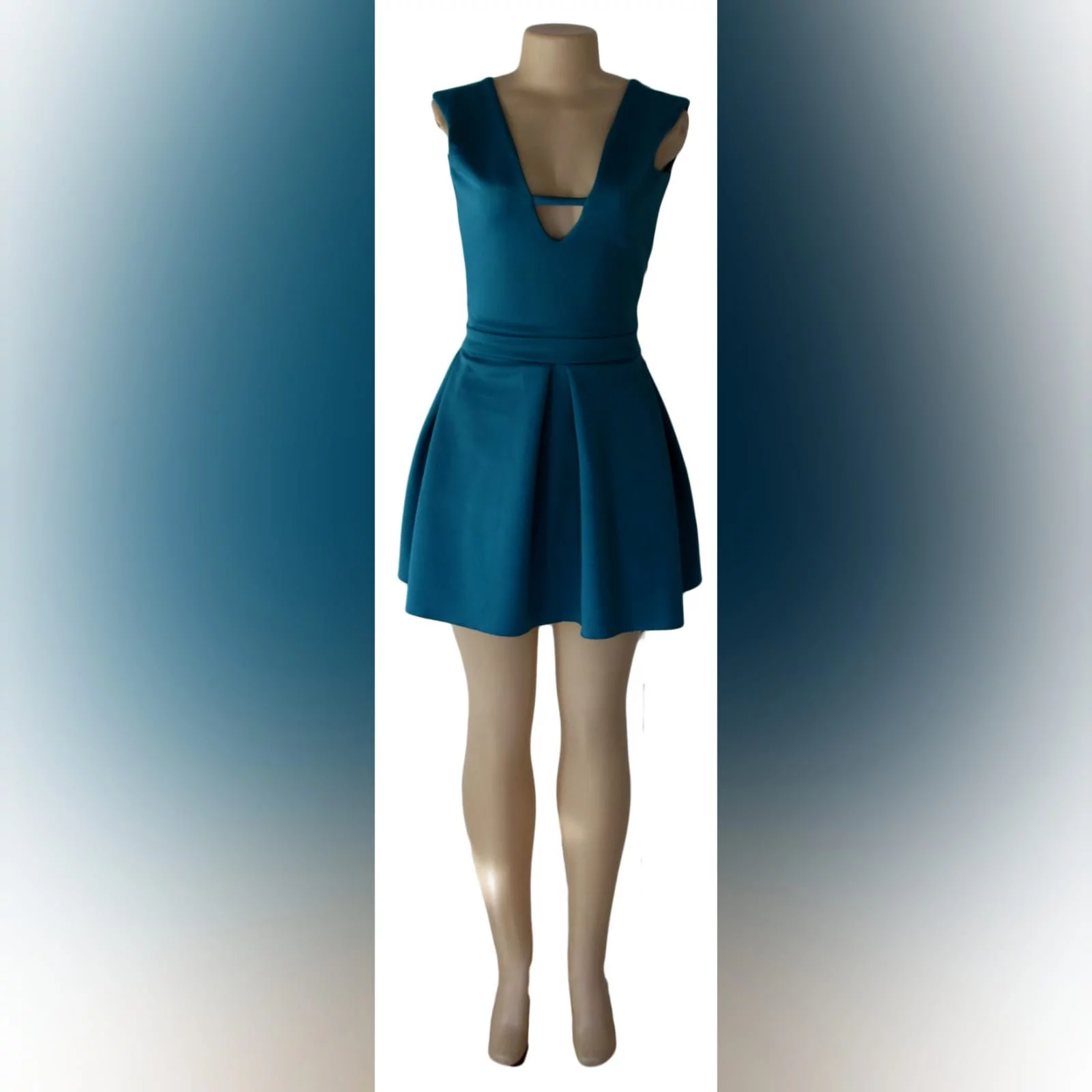Turquoise green short smart casual dress 1 turquoise green short smart casual dress with a v neckline in front and a low v open back, with a waistband, and wide pleats on the bottom.