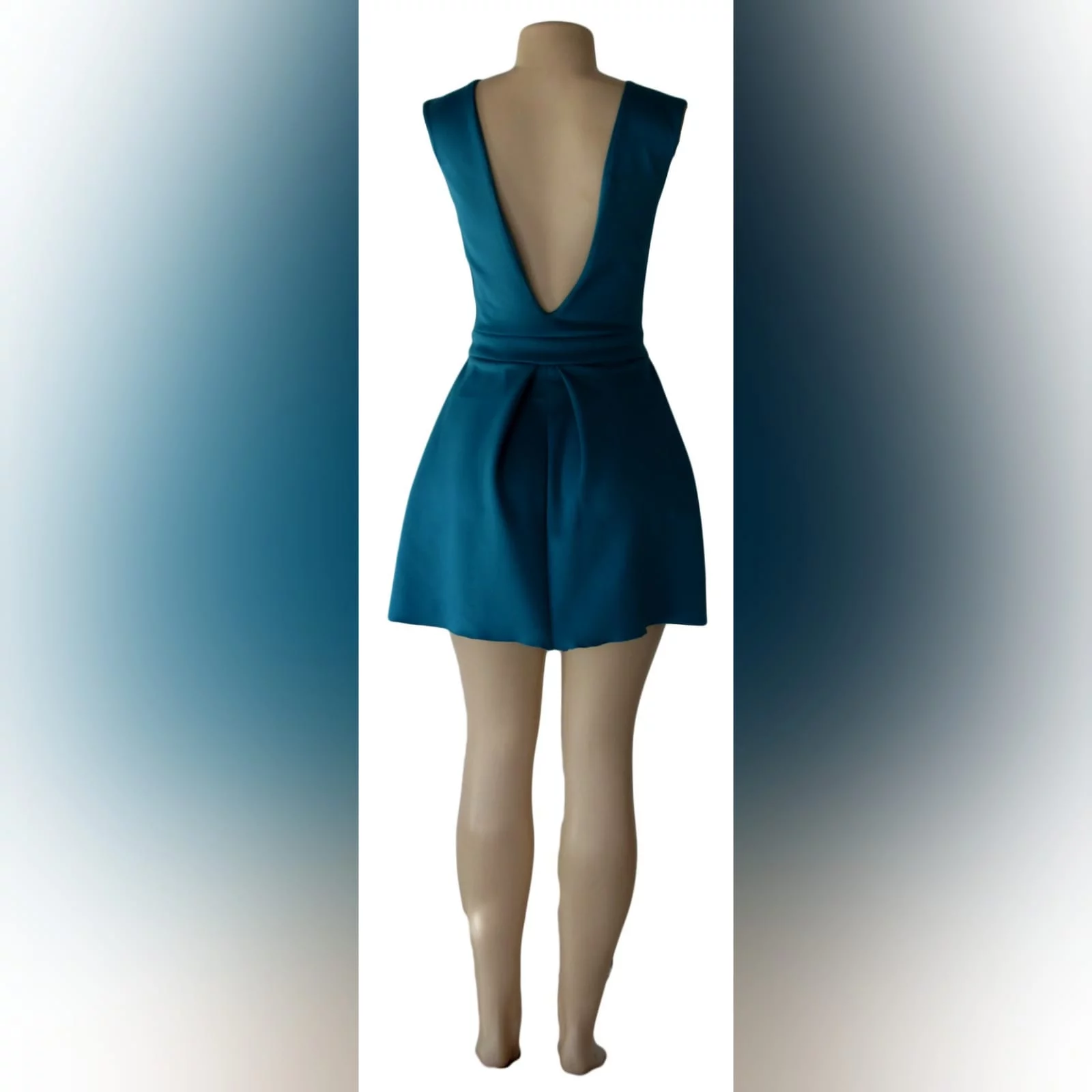Turquoise green short smart casual dress 2 turquoise green short smart casual dress with a v neckline in front and a low v open back, with a waistband, and wide pleats on the bottom.