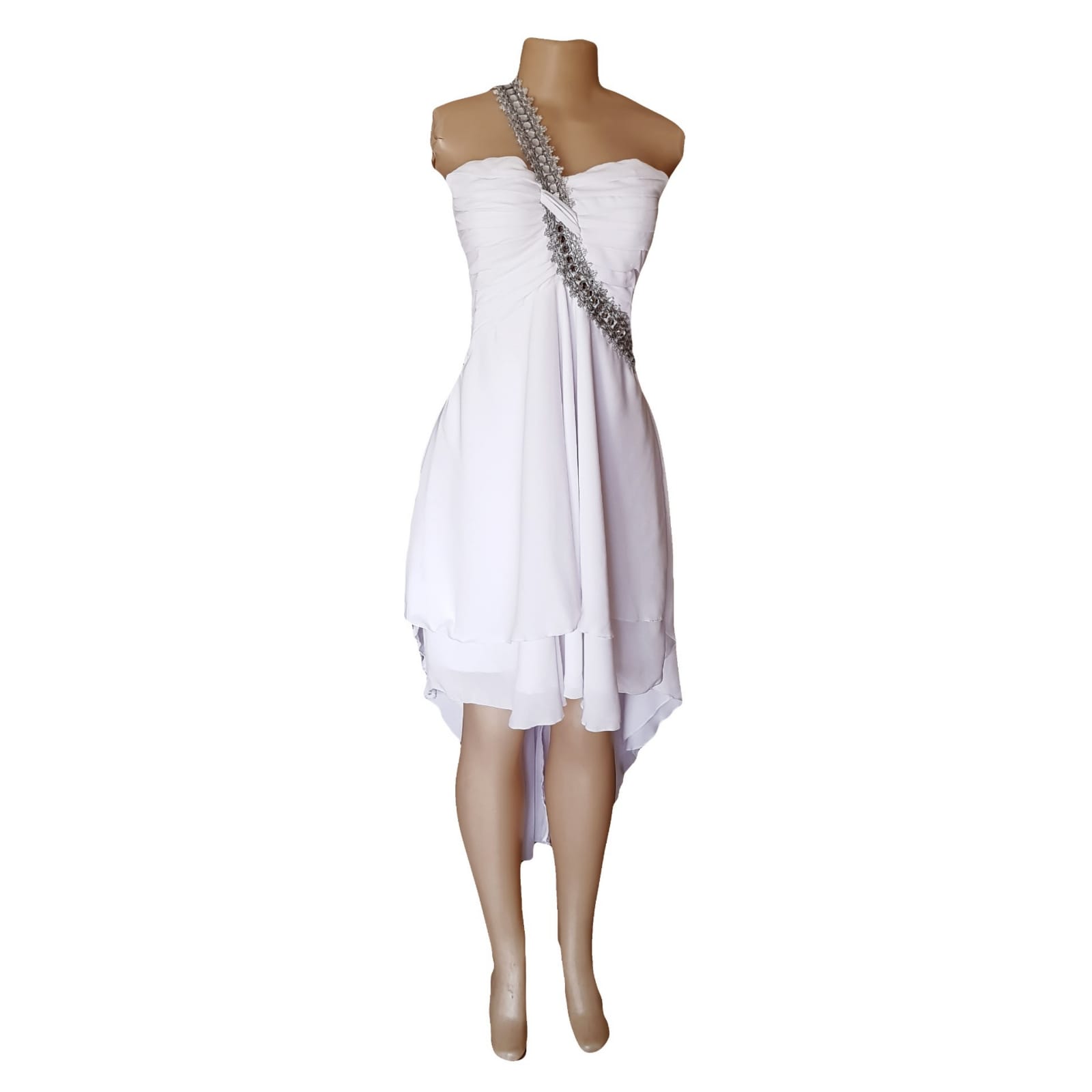 White hi lo beach wedding dress with ruched bodice 8 white hi lo beach wedding dress with ruched bodice and silver detailed strap in an angle from waist over the shoulder to the back. Chiffon bride dress with a doubler layer hi lo.