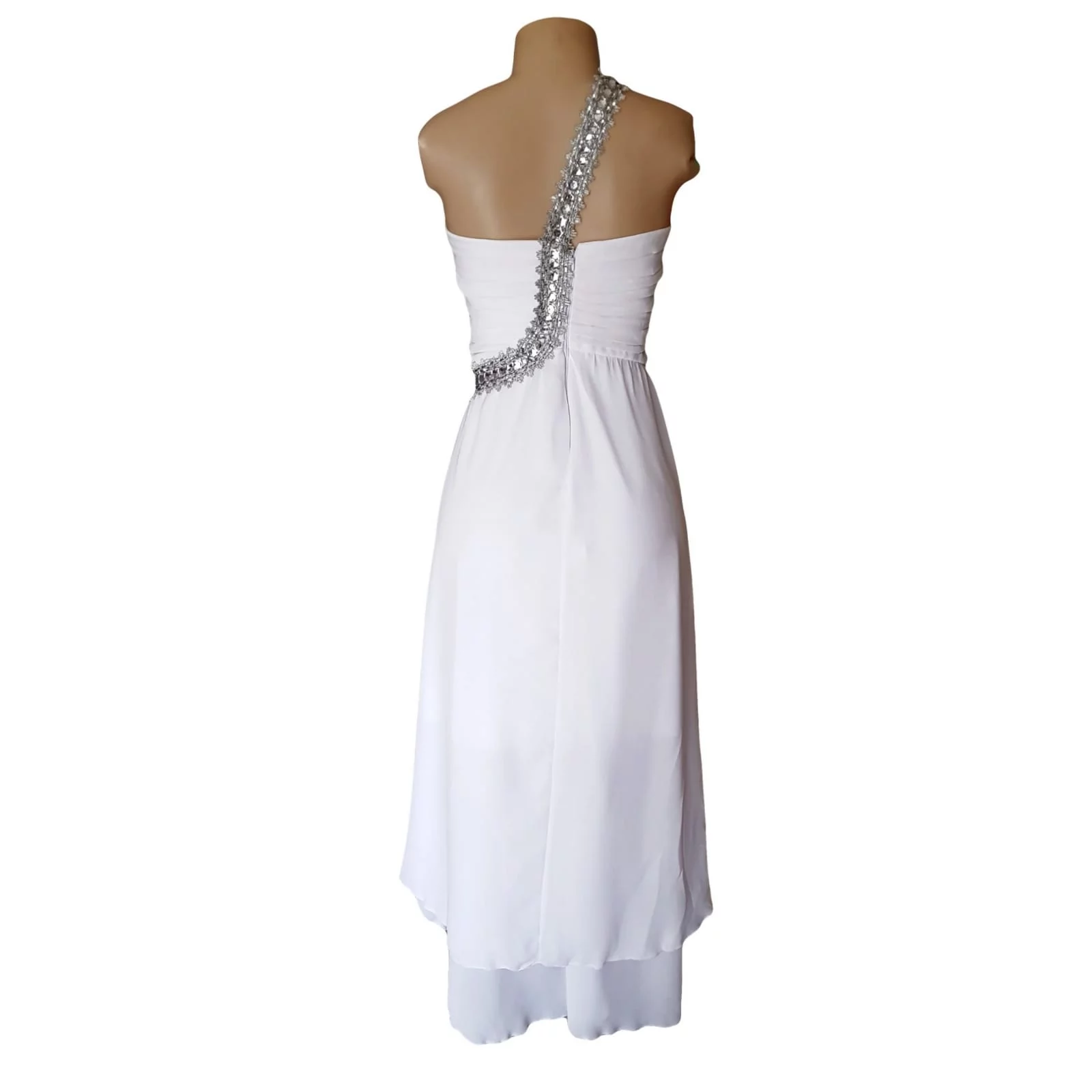 White hi lo beach wedding dress with ruched bodice 5 white hi lo beach wedding dress with ruched bodice and silver detailed strap in an angle from waist over the shoulder to the back. Chiffon bride dress with a doubler layer hi lo.