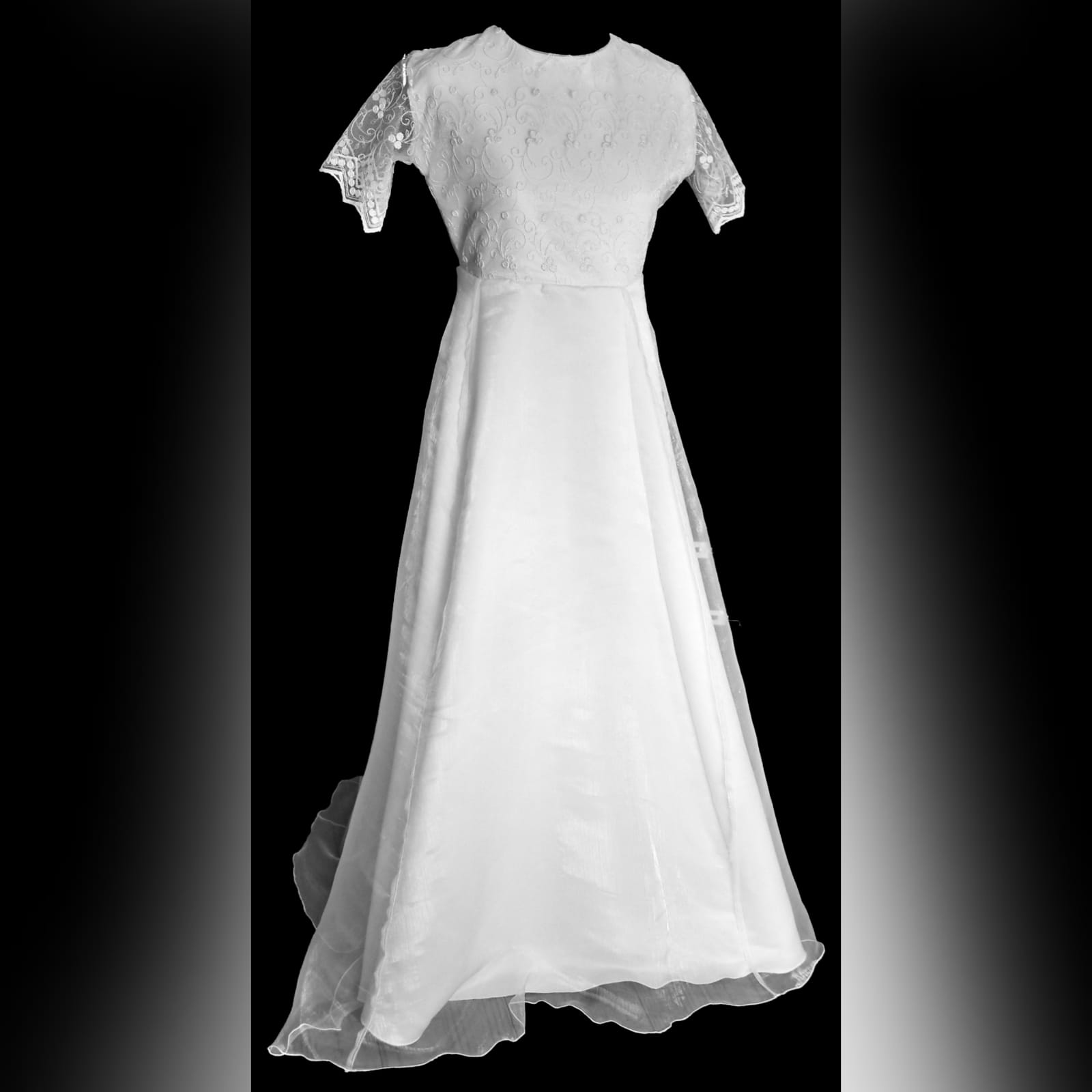 Glitter lace confirmation dress 3 white holy communion dress with a lace glitter bodice and scalloped short sleeves.