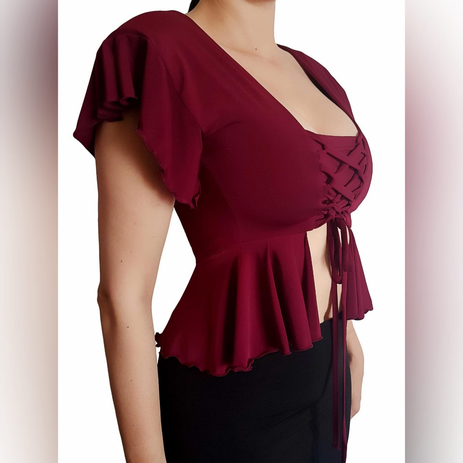Maroon sexy casual top high waist peplum 1 maroon sexy casual top, with a high waist peplum. Lace-up detail in the front to adjust fit. This elegant top has dramatic shoulders which adds a touch of couture to the look. Handmade top, unique look, and a special piece that you can add to your wardrobe. We offer this high shoulder top in several colours.