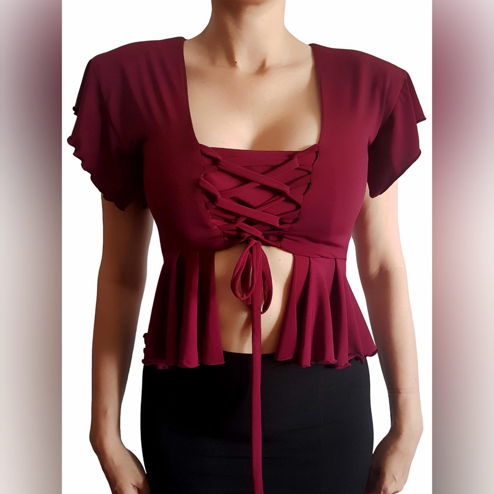 Maroon sexy casual top high waist peplum 2 maroon sexy casual top, with a high waist peplum. Lace-up detail in the front to adjust fit. This elegant top has dramatic shoulders which adds a touch of couture to the look. Handmade top, unique look, and a special piece that you can add to your wardrobe. We offer this high shoulder top in several colours.