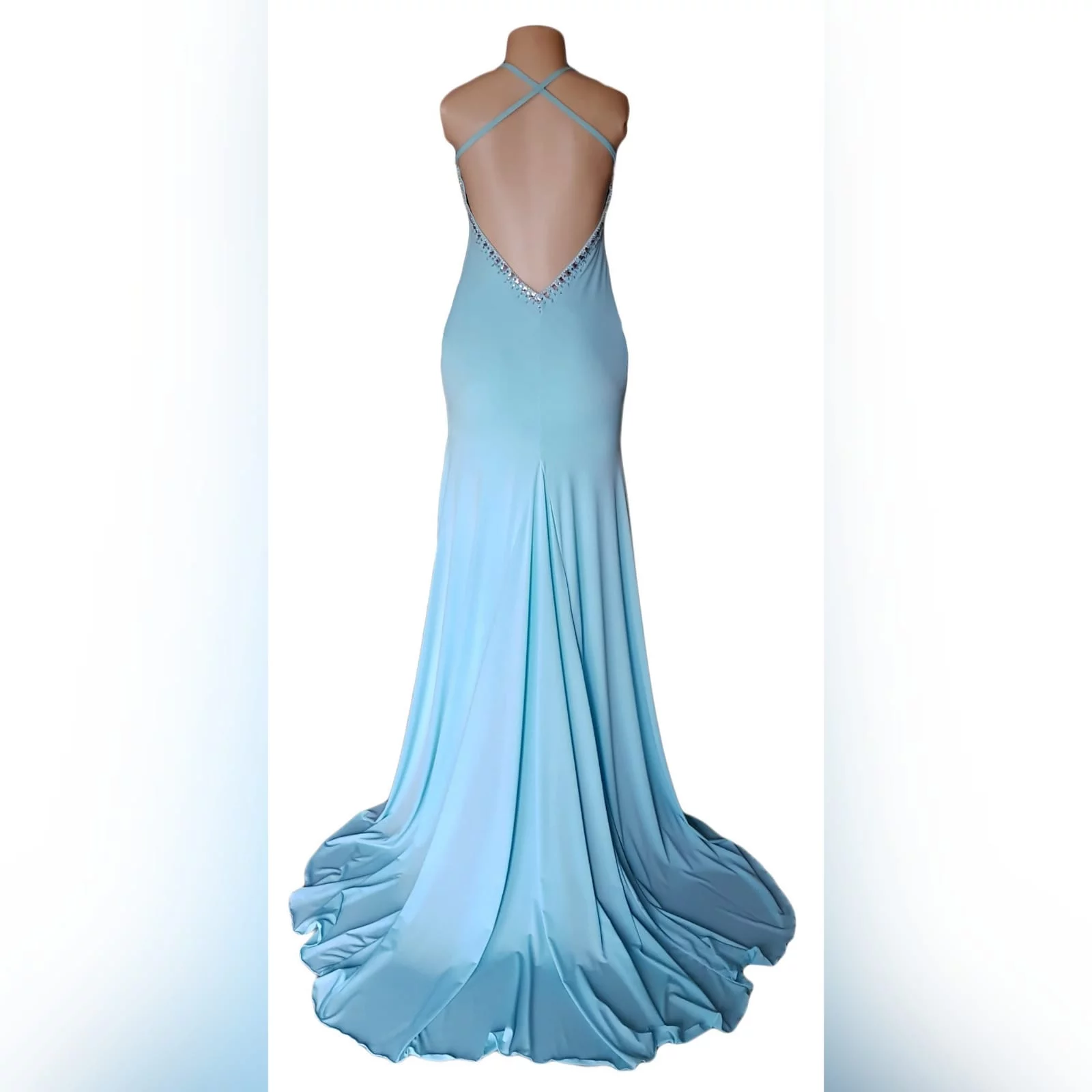 Aqua blue and silver prom dress 5 aqua blue and silver prom dress with a rounded neckline, open low v back with thin crossed straps, slit and a train. Dress detailed with silver beads and stones.