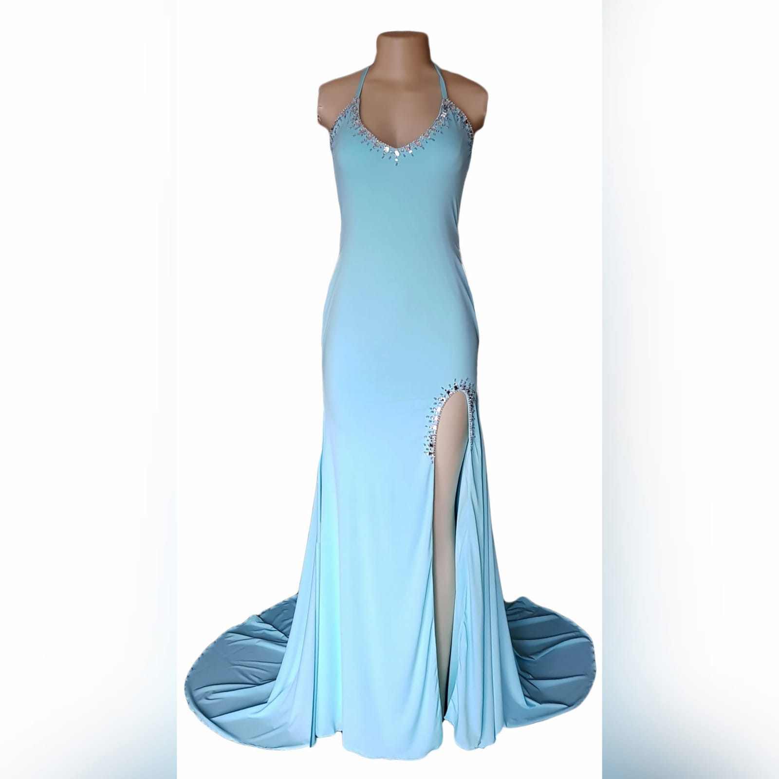 Aqua blue and silver prom dress 8 aqua blue and silver prom dress with a rounded neckline, open low v back with thin crossed straps, slit and a train. Dress detailed with silver beads and stones.