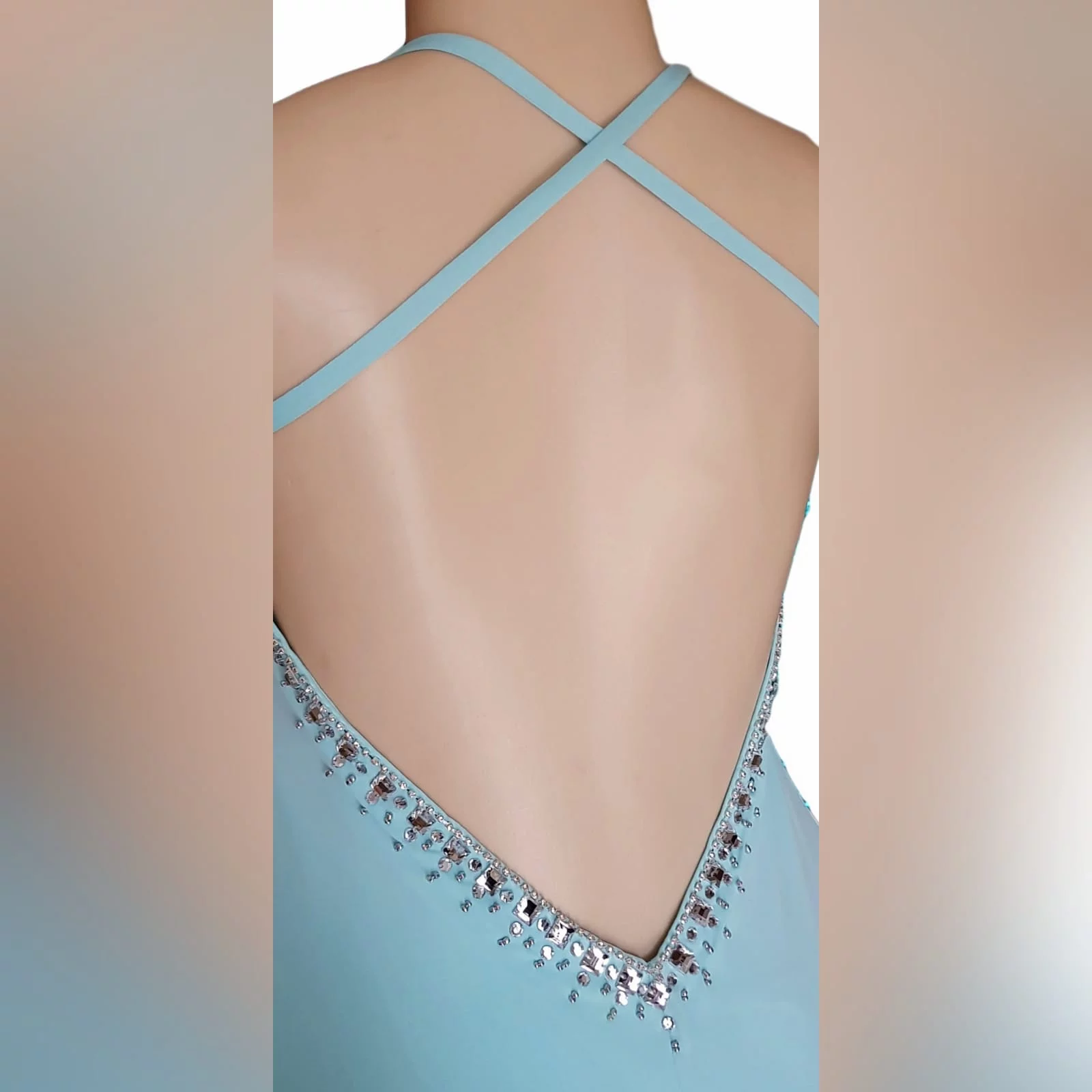 Aqua blue and silver prom dress 4 aqua blue and silver prom dress with a rounded neckline, open low v back with thin crossed straps, slit and a train. Dress detailed with silver beads and stones.