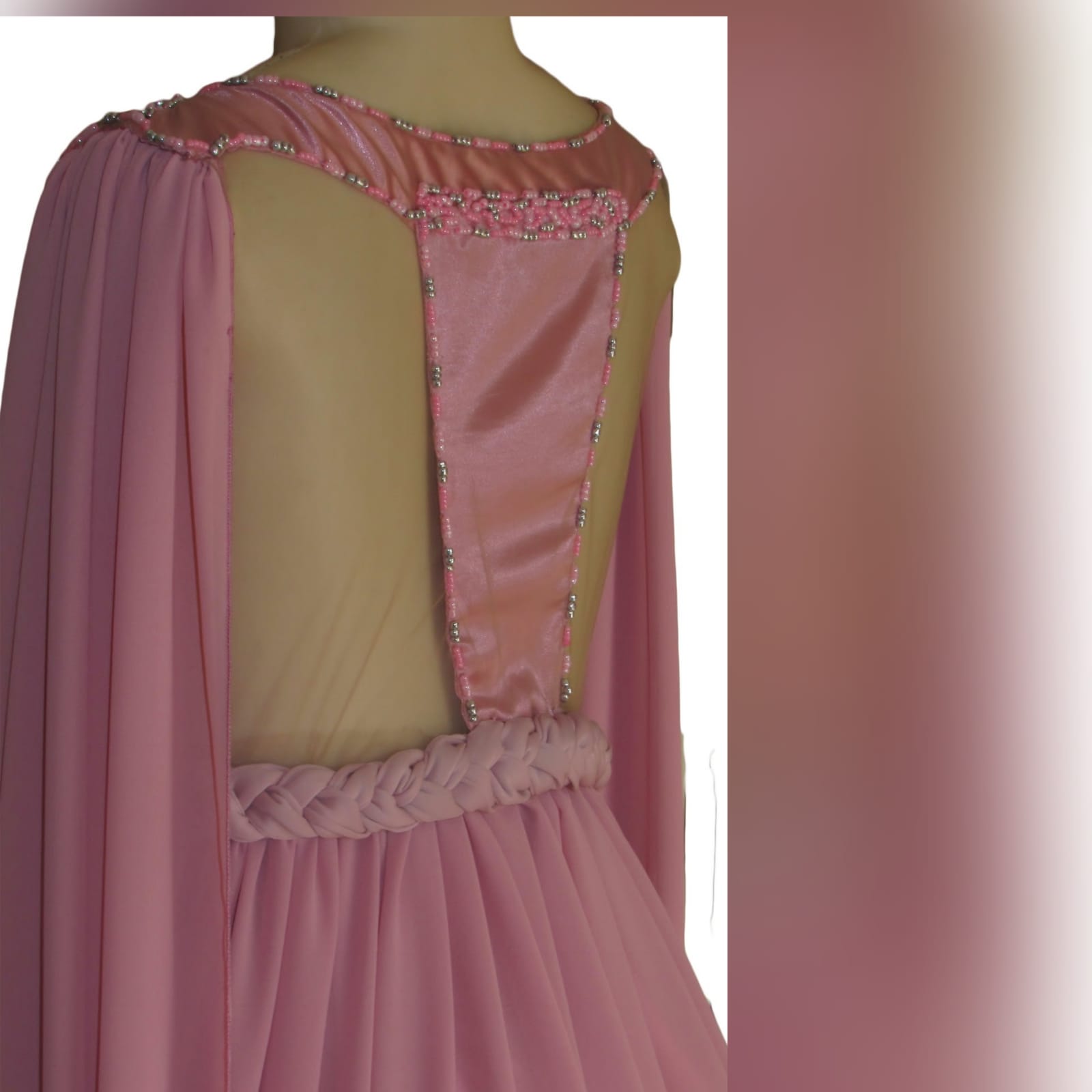 Dusty pink chiffon beaded prom dress 2 dusty pink chiffon beaded prom dress, bateau neckline effect with an illusion back, fully beaded bodice, plaited belt detail with a slit and a train. Shoulders with chiffon draping creating a goddess look.