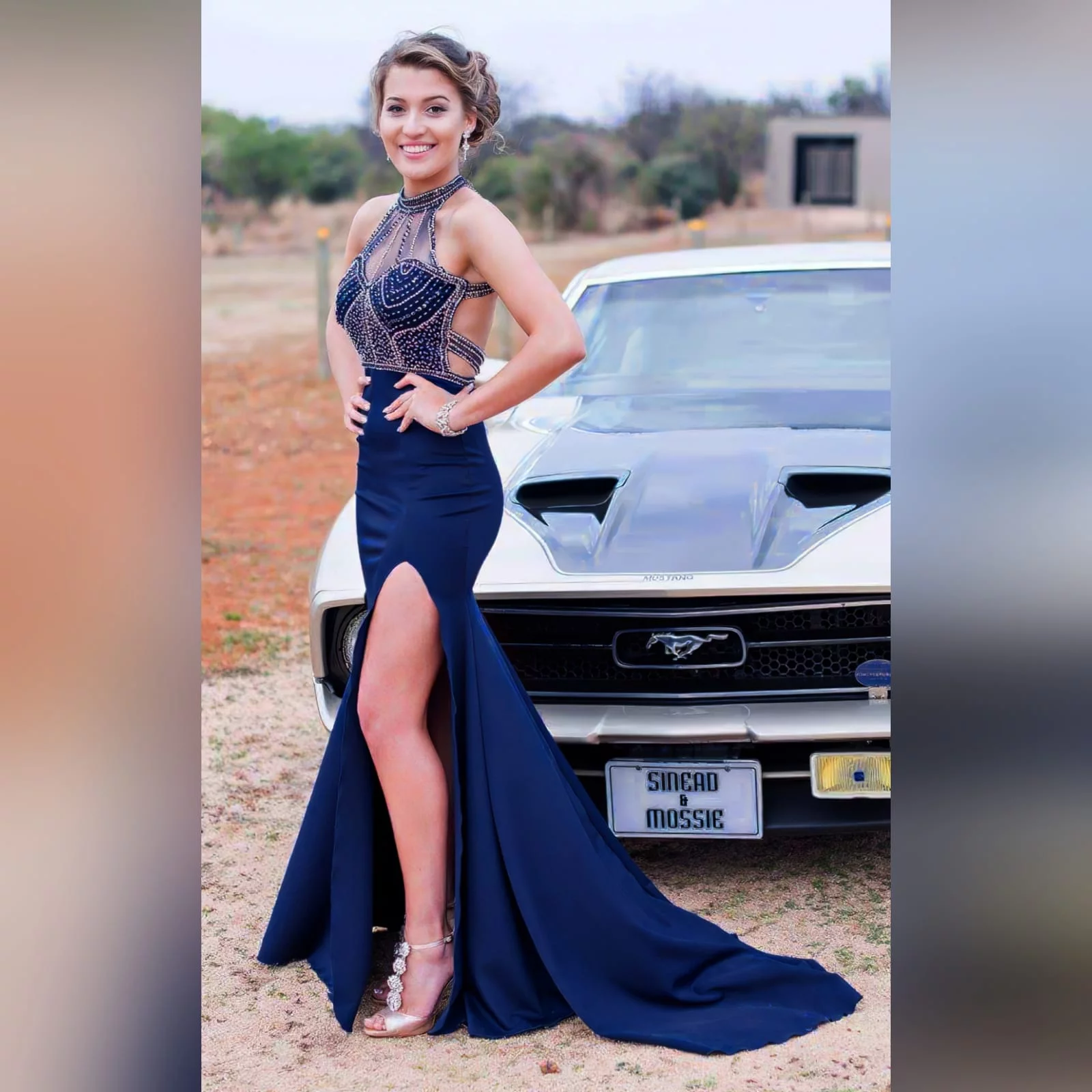 Navy blue silver beaded prom dress 1 navy blue silver beaded prom dress with an illusion neckline and a choker effect. Backless design detailed with beaded straps. Fitted bottom with a slit and a train.
