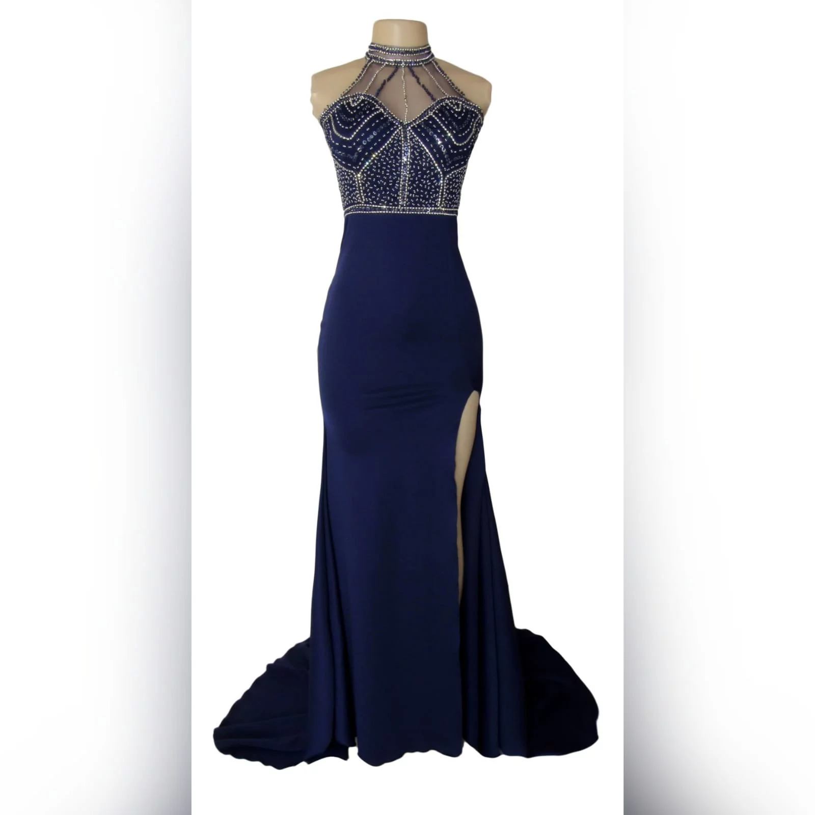 Navy blue silver beaded prom dress 4 navy blue silver beaded prom dress with an illusion neckline and a choker effect. Backless design detailed with beaded straps. Fitted bottom with a slit and a train.
