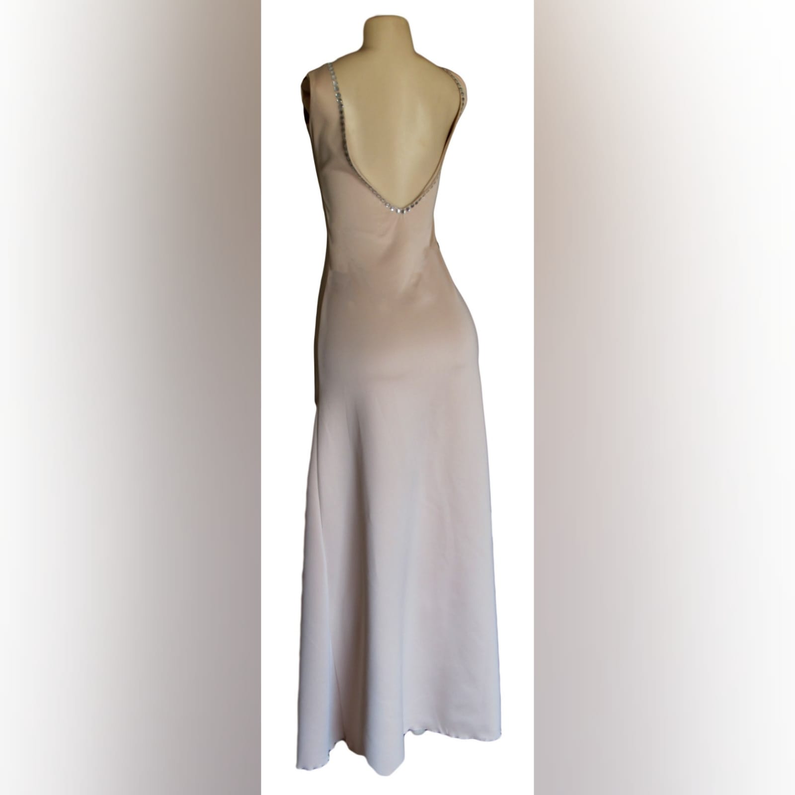Nude simple elegant formal dress 4 nude simple elegant formal dress with a sweetheart neckline and a low rounded open back. Detailed with silver beads and a slit.