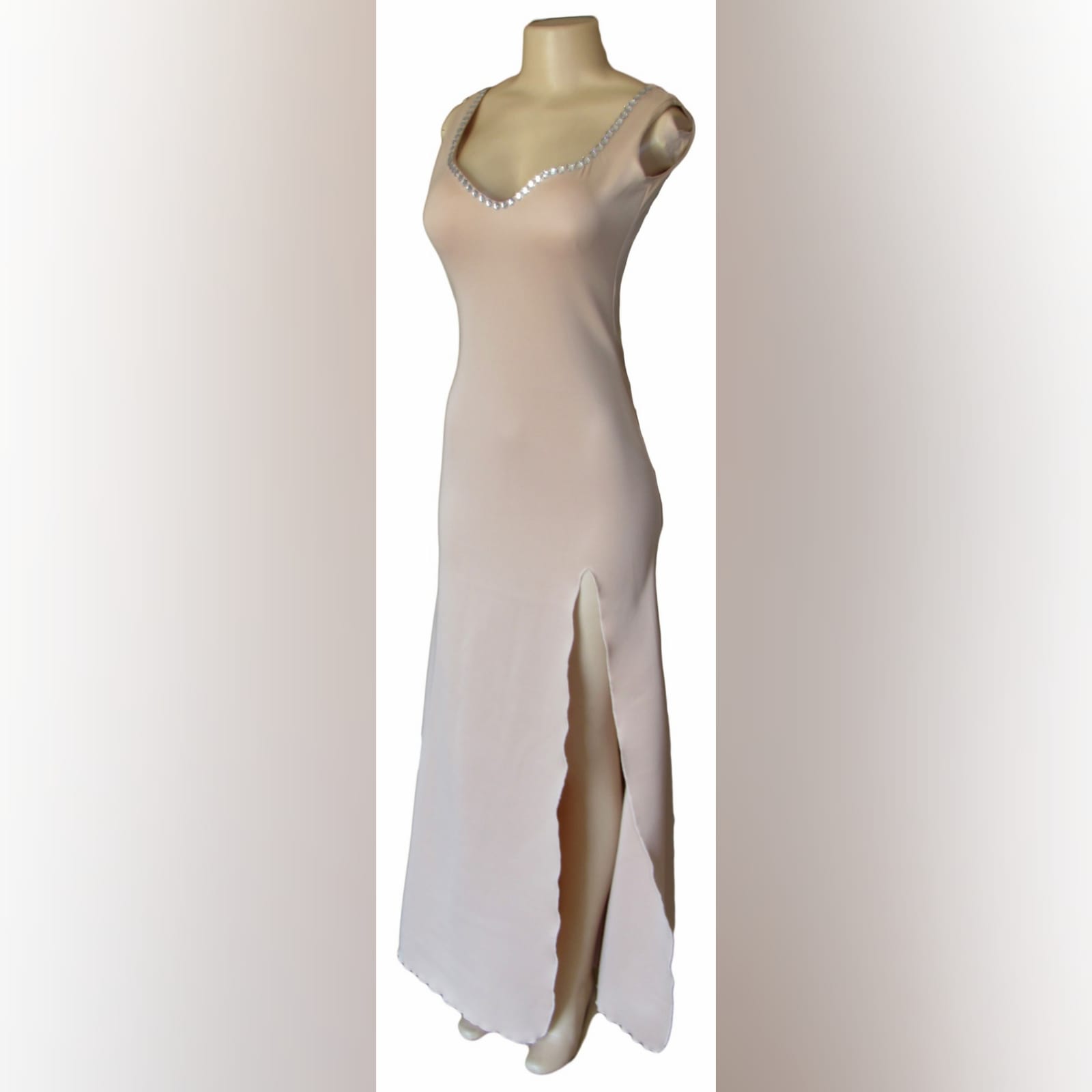 Nude simple elegant formal dress 5 nude simple elegant formal dress with a sweetheart neckline and a low rounded open back. Detailed with silver beads and a slit.