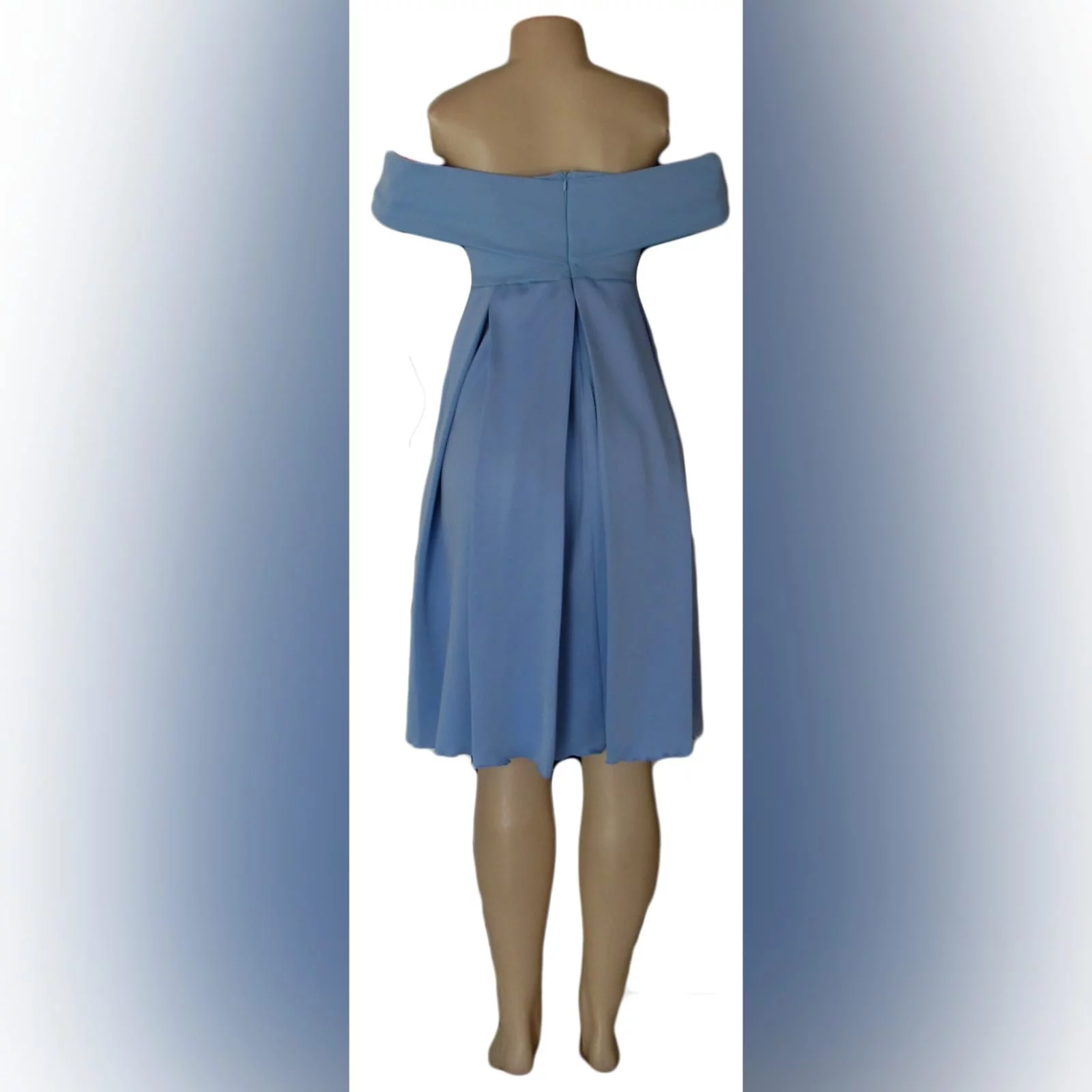 Short pale blue pleated cocktail dress 5 short pale blue pleated cocktail dress with a crossed bust design creating off shoulder short sleeves, pleated bottom with pockets.