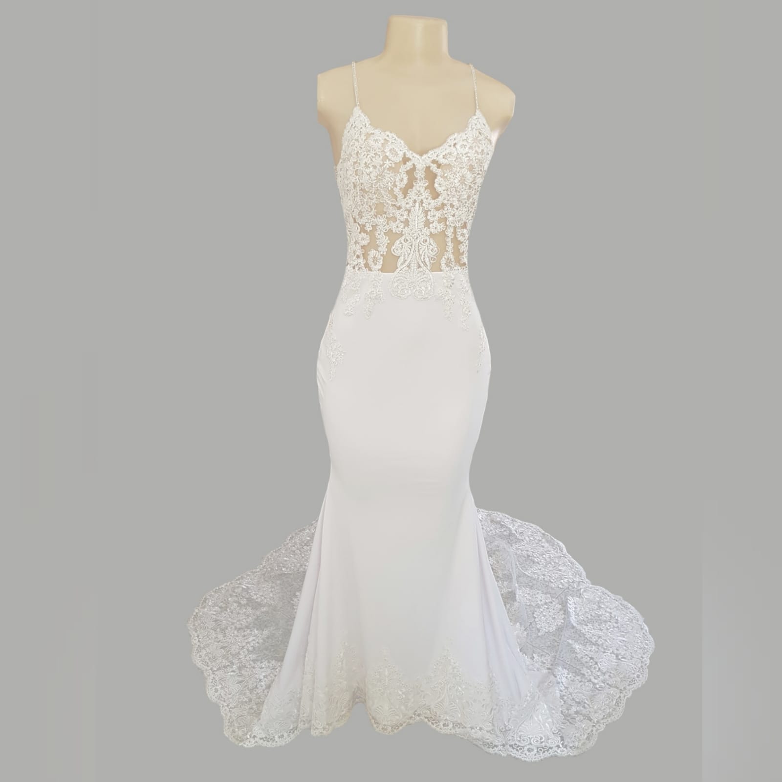 White lace mermaid wedding dress with lace train 12 white lace mermaid wedding dress, lace bodice with a v neckline, low open back and thin shoulder straps detailed with diamante. Lace from the waist down, creating a long sheer lace train. With a train hookup and a matching garter.