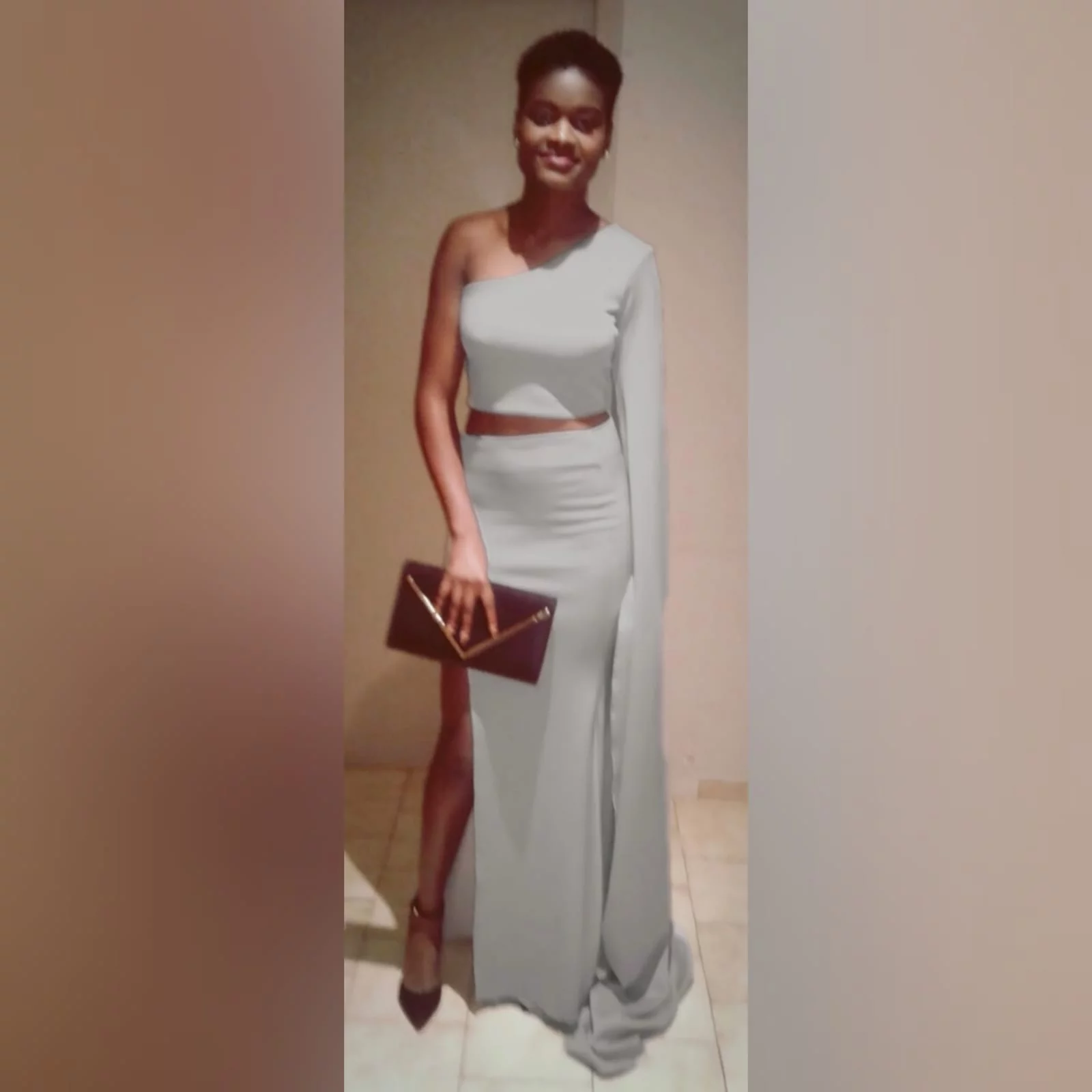 2 piece light grey matric dance dress 6 2 piece light grey matric dance dress, crop top with a single shoulder and a long wide sleeve creating a train. With a fitted long skirt, with a high slit.