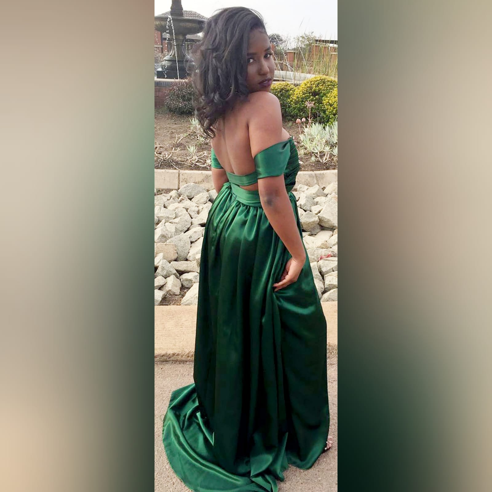 Emerald green satin flowy formal dress 7 emerald green satin off shoulder flowy formal dress, with a pleated bodice off shoulder short sleeves, naked back detailed with straps. A crossed slit and a small train.