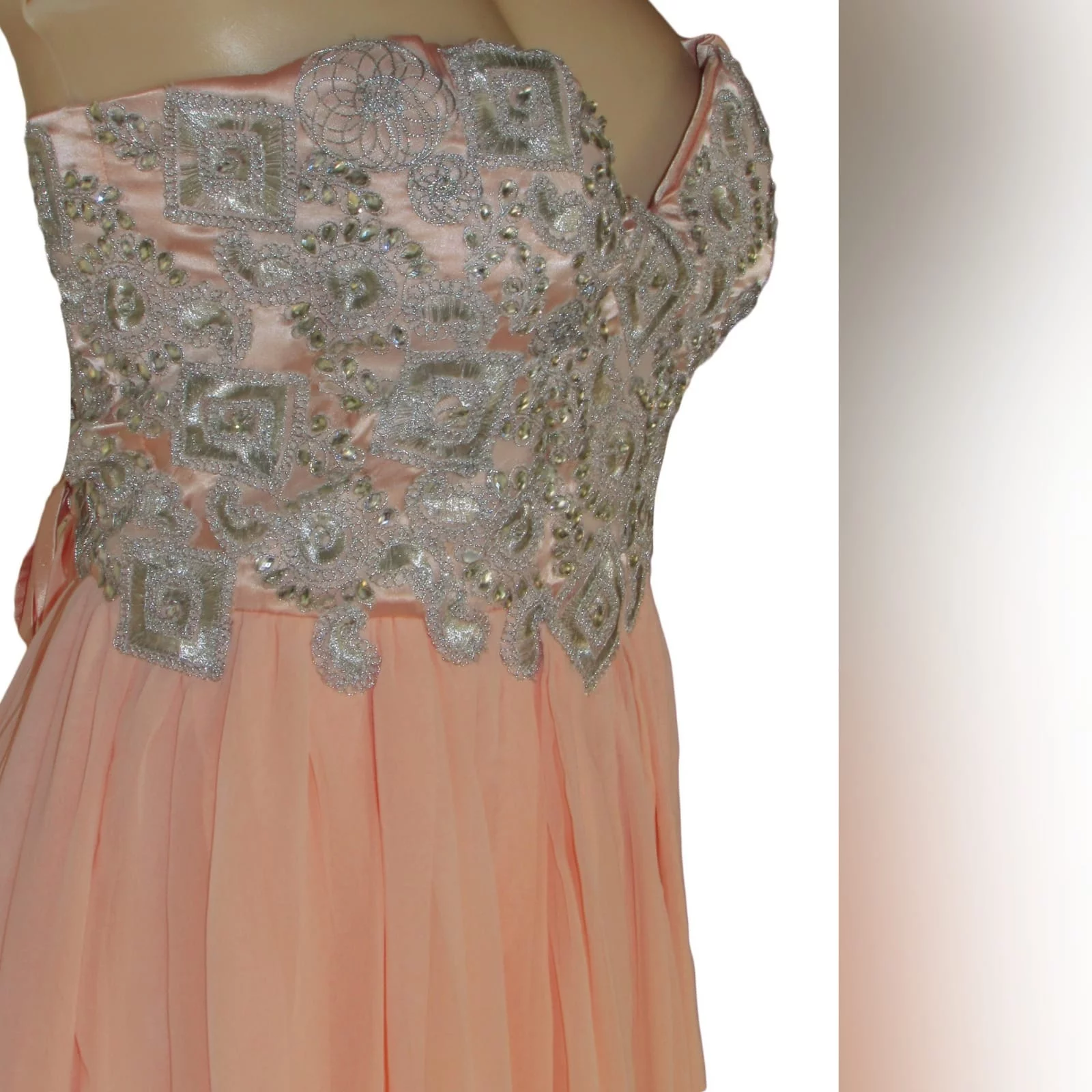 Peach and silver fun prom dress 3 peach and silver fun prom dress. Bodice detailed with appliques and beads, with a lace-up back. Bottom with gathered chiffon and an overlayer opened in front.