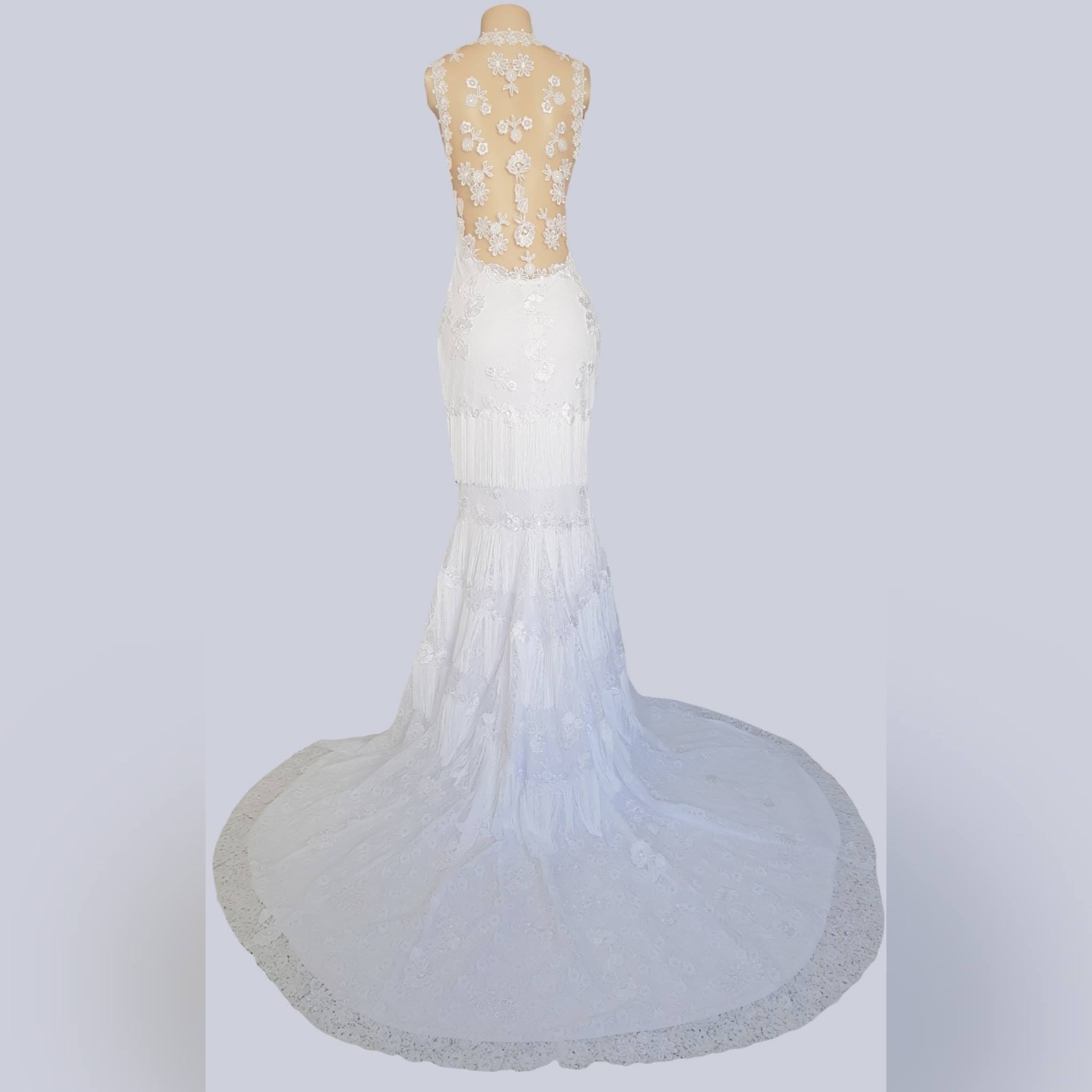 White lace mermaid bridal dress 14 <blockquote>"above all be the heroine of your life, not the victim" nora ephron</blockquote> this unique mermaid lace wedding dress was created for my client in angola. White lace mermaid bridal dress detailed with lace appliques throughout, illusion back and neckline and a train. With tassels throughout the bottom to add a fun movement when dancing at the wedding ceremony. With a long veil that goes over the head #mariselaveludo #passion4fashion #weddingdress #bridedress #mermaidweddingdress #lacewhitedress #tassels #custommadedress